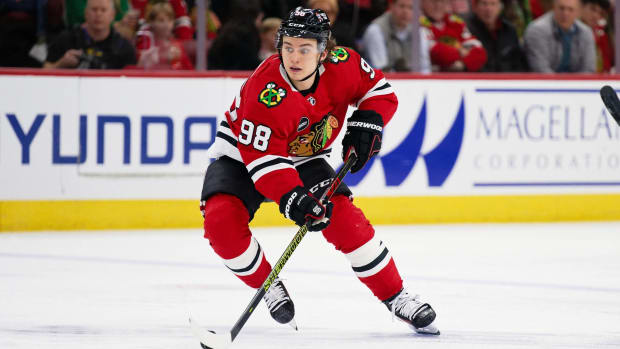 Blackhawks forward Connor Bedard skates with the puck during a game.